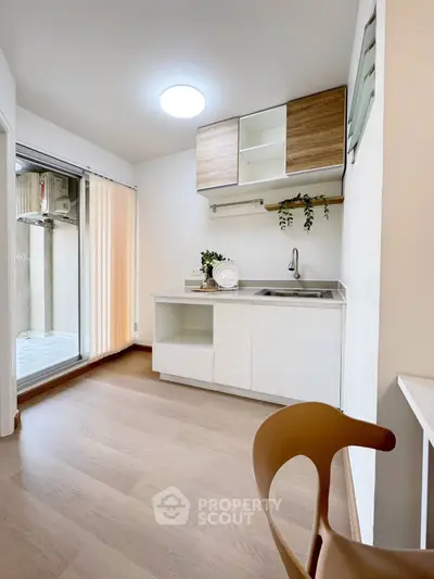 Modern kitchen with sleek design and open layout, featuring wooden cabinets and bright lighting.