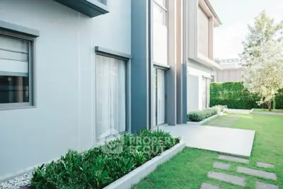 Modern exterior of a stylish home with lush garden and sleek design.