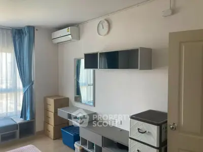 Modern bedroom with air conditioning and ample storage space in a bright apartment.