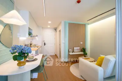Chic modern living room with open kitchen, stylish decor, and cozy seating area.
