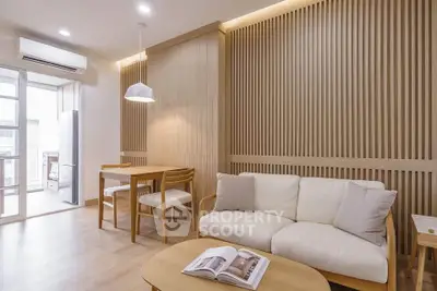 Modern living room with wooden accents and open layout, featuring cozy seating and dining area.