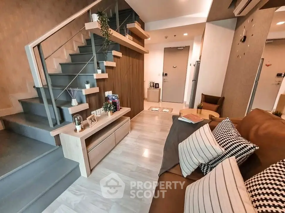 Modern living room with stylish staircase and cozy seating area