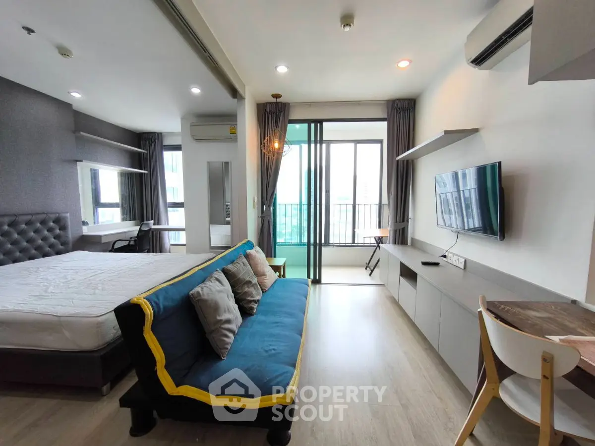 Modern studio apartment with stylish decor and balcony access