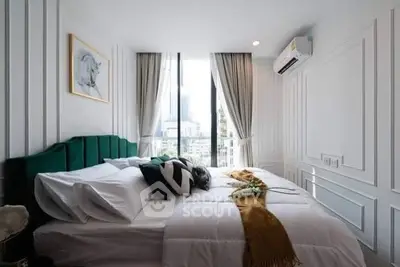 Luxurious bedroom with elegant decor and city view, featuring plush bedding and modern design.