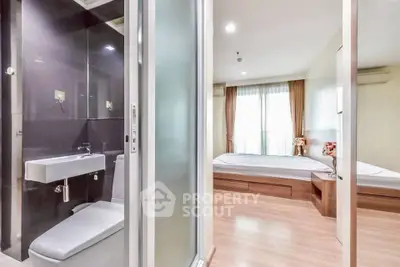 Modern apartment with sleek bathroom and cozy bedroom, featuring elegant design and natural light.