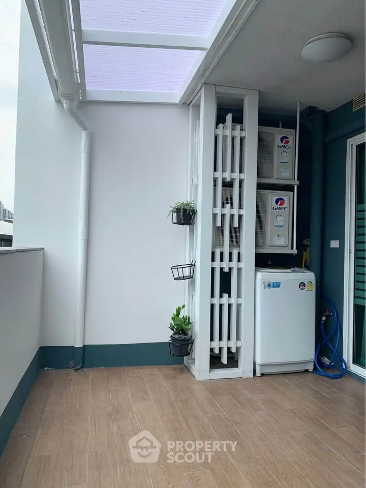 Spacious balcony with modern design and utility area, perfect for urban living.