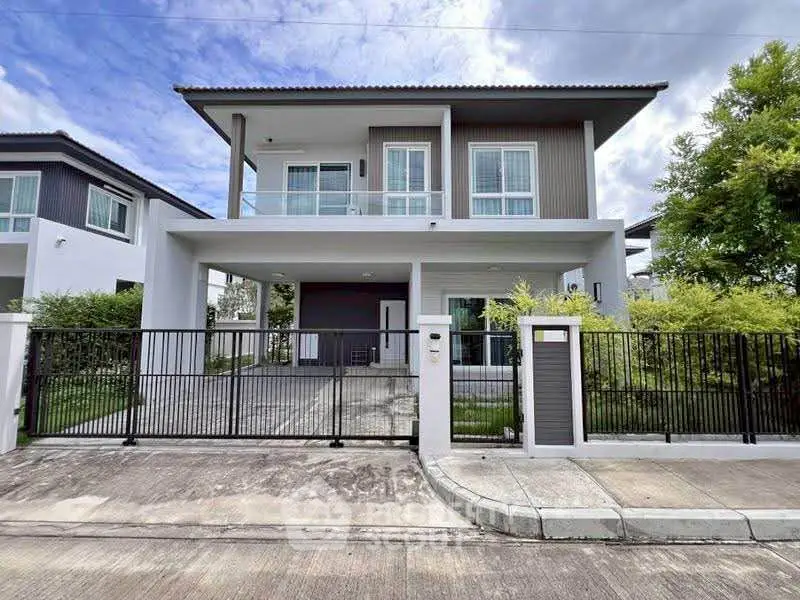 Modern two-story house with spacious driveway and sleek design in a serene neighborhood.
