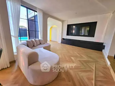 Spacious modern living room with elegant decor and large TV setup