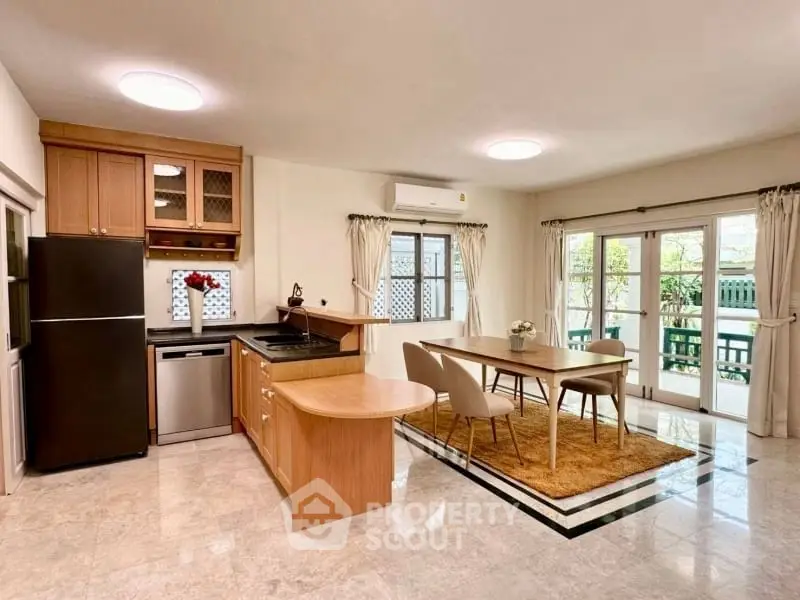 Spacious kitchen and dining area with modern appliances and natural light