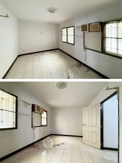 Spacious room with tiled flooring and large windows, ideal for customization and renovation.