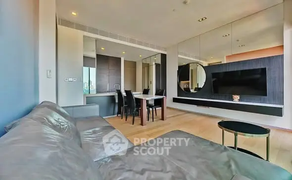 Modern living room with sleek furniture and large mirror wall