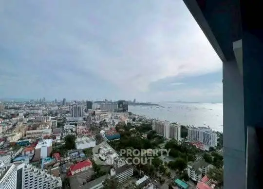 Stunning high-rise view of cityscape and ocean horizon, perfect for urban living.