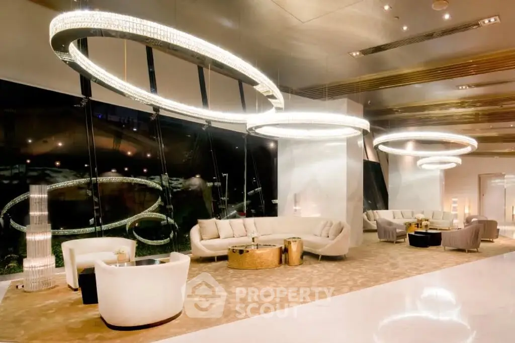 Luxurious modern lobby with elegant seating and stunning circular chandeliers.
