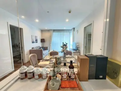 Elegant dining area with modern decor and cozy living room in a stylish apartment.