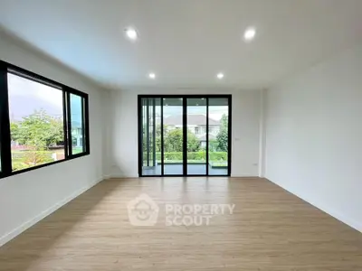 Spacious living room with large windows and balcony view