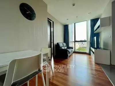 Modern living room with wooden flooring and large window view