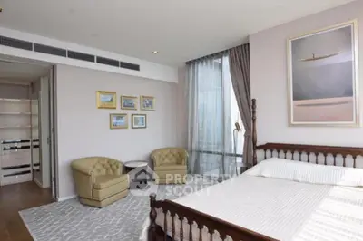 Luxurious bedroom with elegant decor and large windows offering natural light