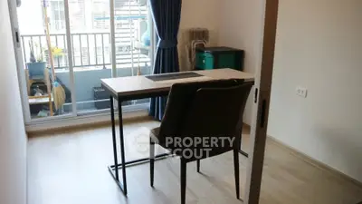 Modern study room with desk and chair, featuring a balcony view and natural light.