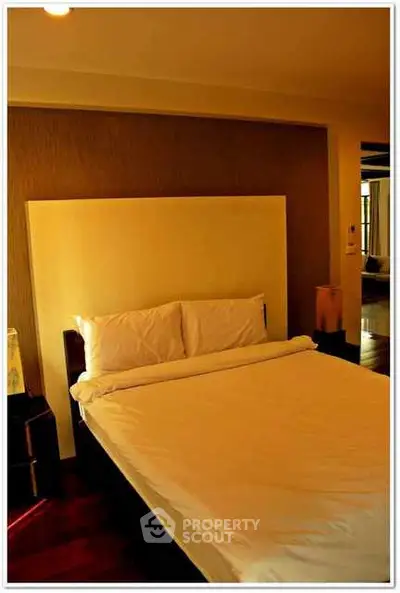 Cozy bedroom with elegant lighting and plush bedding for ultimate relaxation.