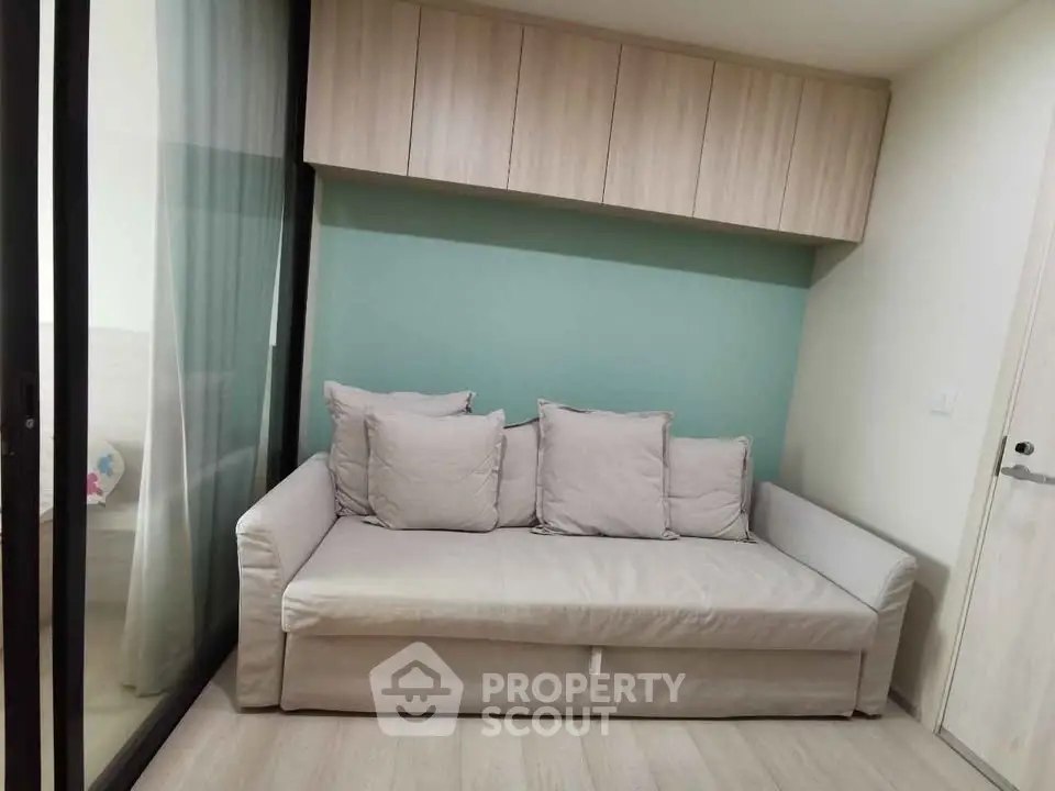 Modern living room with cozy sofa and stylish storage cabinets, perfect for urban living.