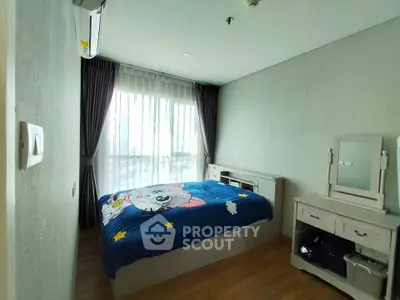 Cozy bedroom with large window and stylish furniture in modern apartment.