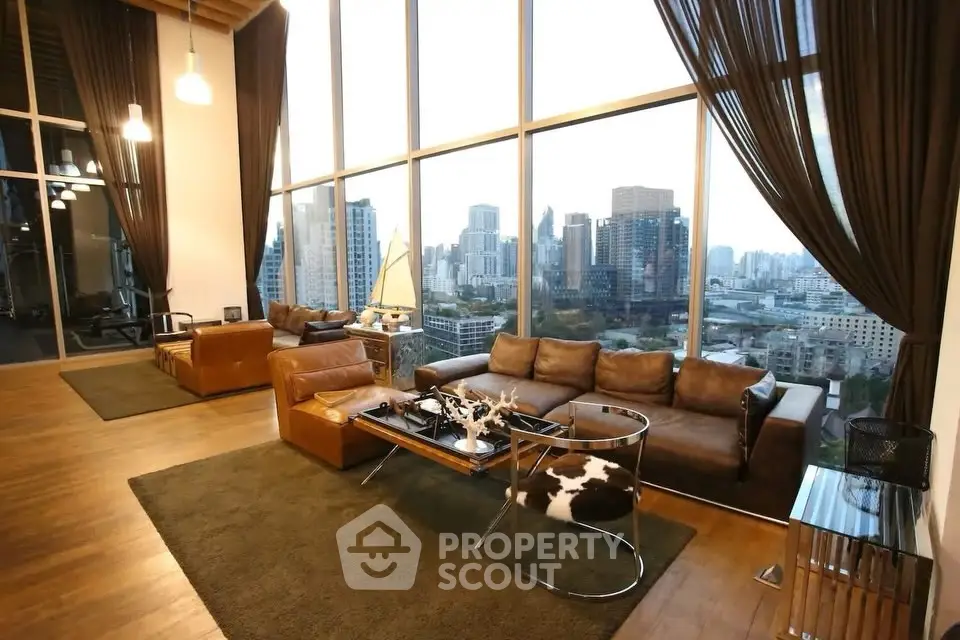 Luxurious high-rise living room with stunning city skyline view and elegant decor.