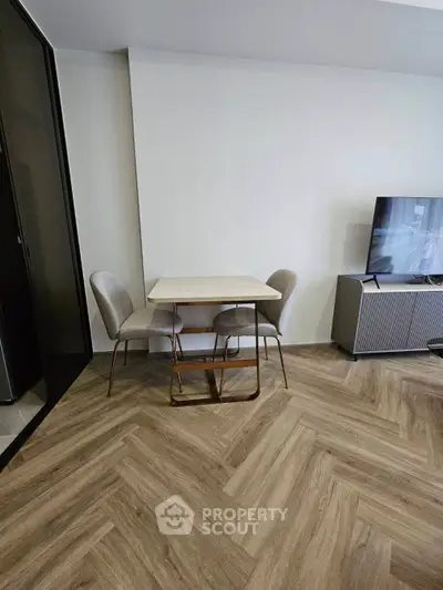 Modern living room with stylish dining set and sleek TV stand