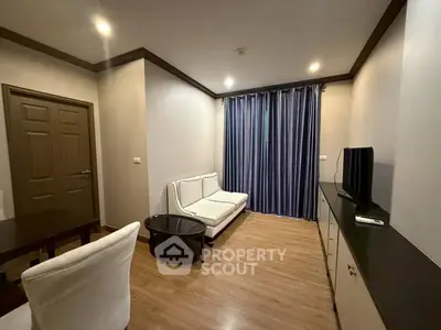 Modern living room with sleek furniture and wooden flooring, perfect for cozy relaxation.