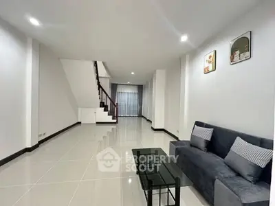 Spacious modern living room with sleek tile flooring and stylish decor