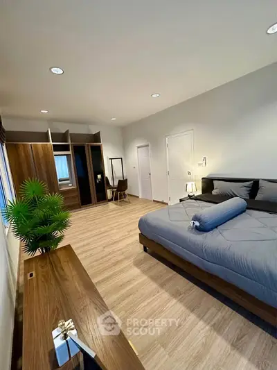 Spacious modern bedroom with stylish decor and ample storage space
