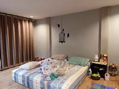 Cozy bedroom with minimalist decor and soft lighting, featuring a comfortable bed and stylish wall art.