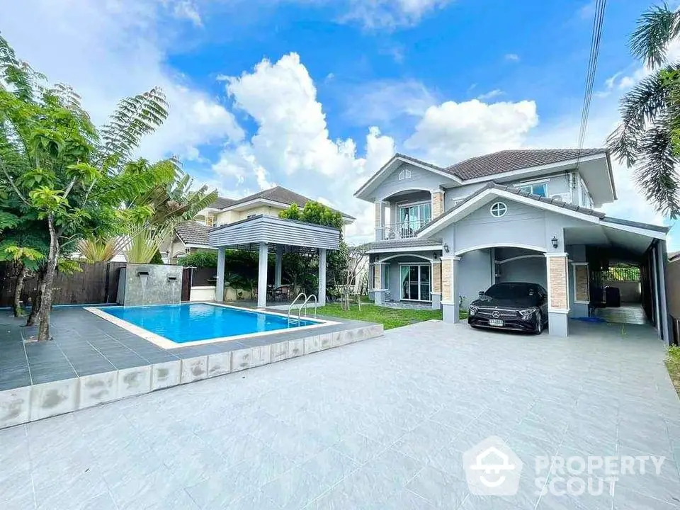 Stunning two-story house with pool and carport in lush tropical setting