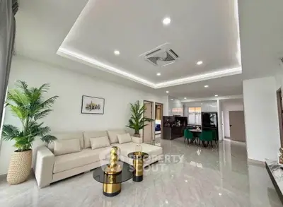 Spacious modern living room with elegant decor and open layout, featuring a cozy sofa and stylish dining area.