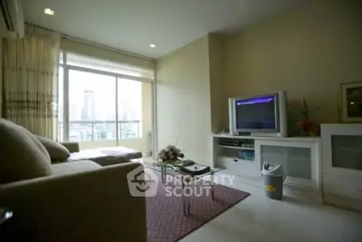 Spacious living room with city view, modern furniture, and natural light.