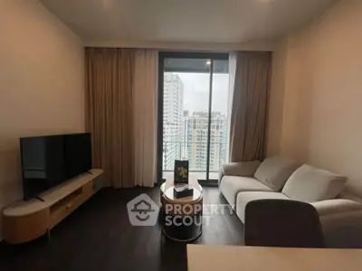 Modern living room with city view, sleek furniture, and large window.