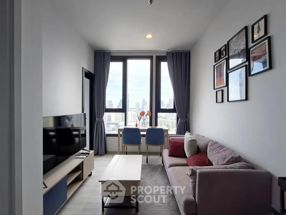 Modern living room with city view, stylish decor, and cozy seating area.