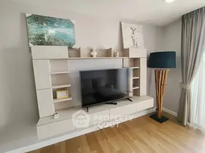 Modern living room with stylish TV unit and elegant floor lamp