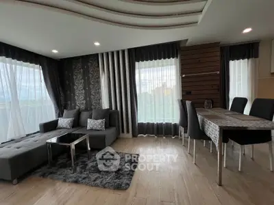 Modern living room with stylish decor and large windows offering natural light