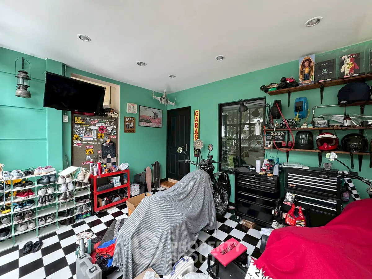 Stylish garage with checkered floor, vibrant teal walls, and organized storage solutions.
