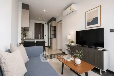 Modern living room with stylish decor and open kitchen layout in a contemporary apartment.
