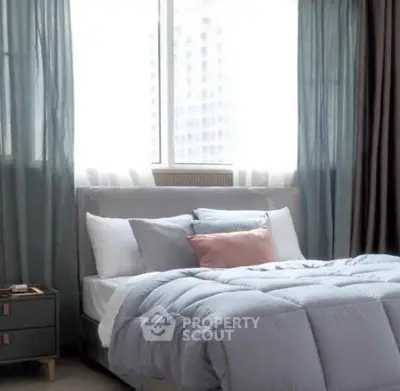 Cozy bedroom with soft bedding and large window view