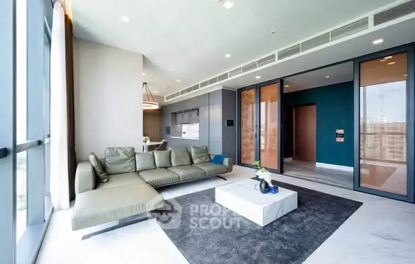 Luxurious modern living room with sleek furniture and large windows offering stunning views.