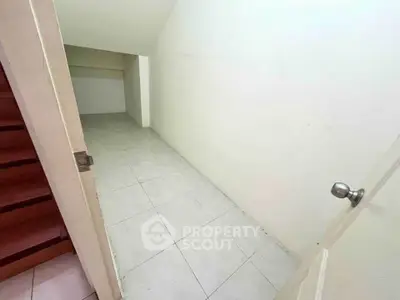 Spacious under-stair storage room with tiled flooring