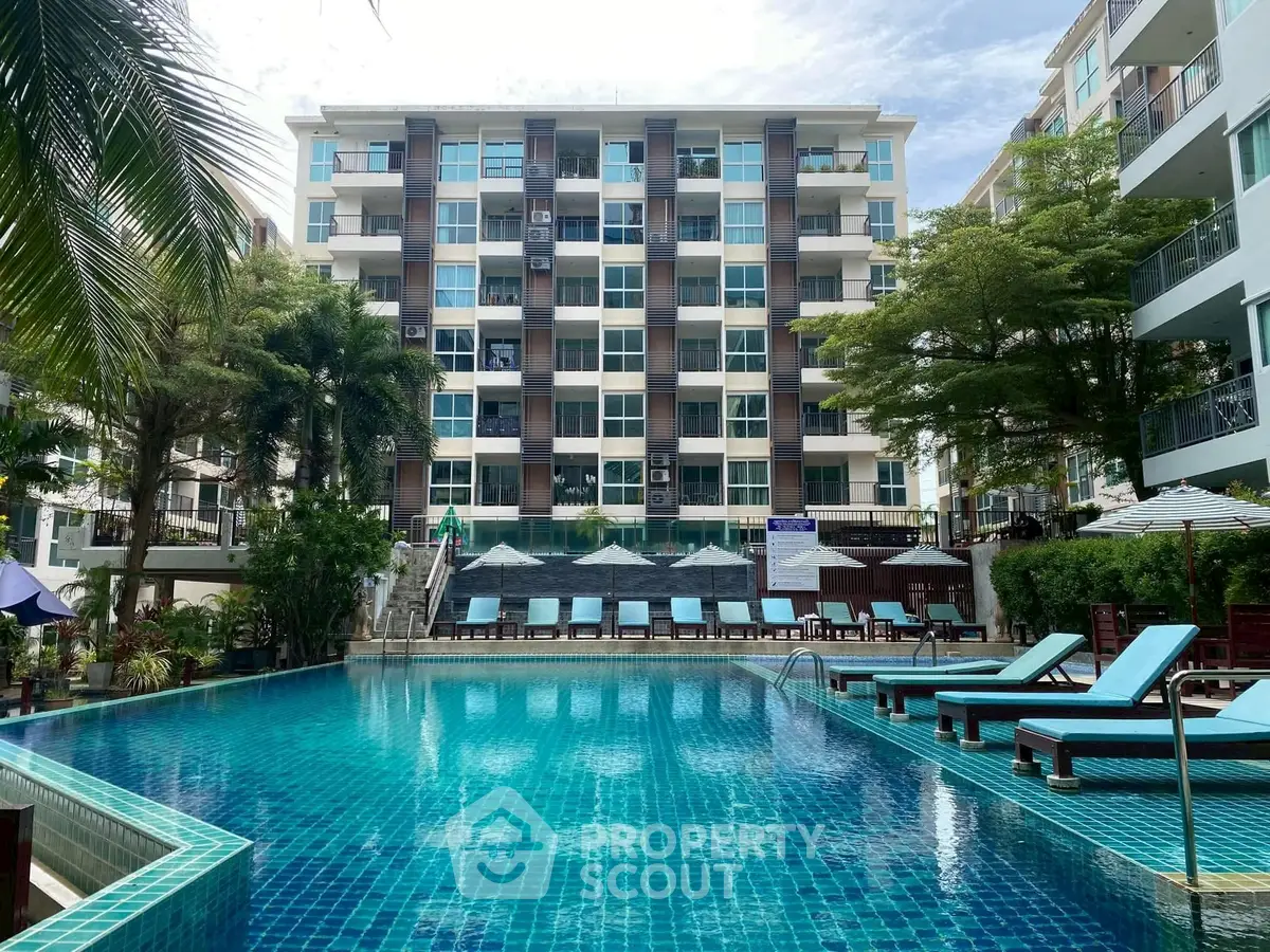 Luxurious condominium with stunning pool and modern amenities in tropical setting.
