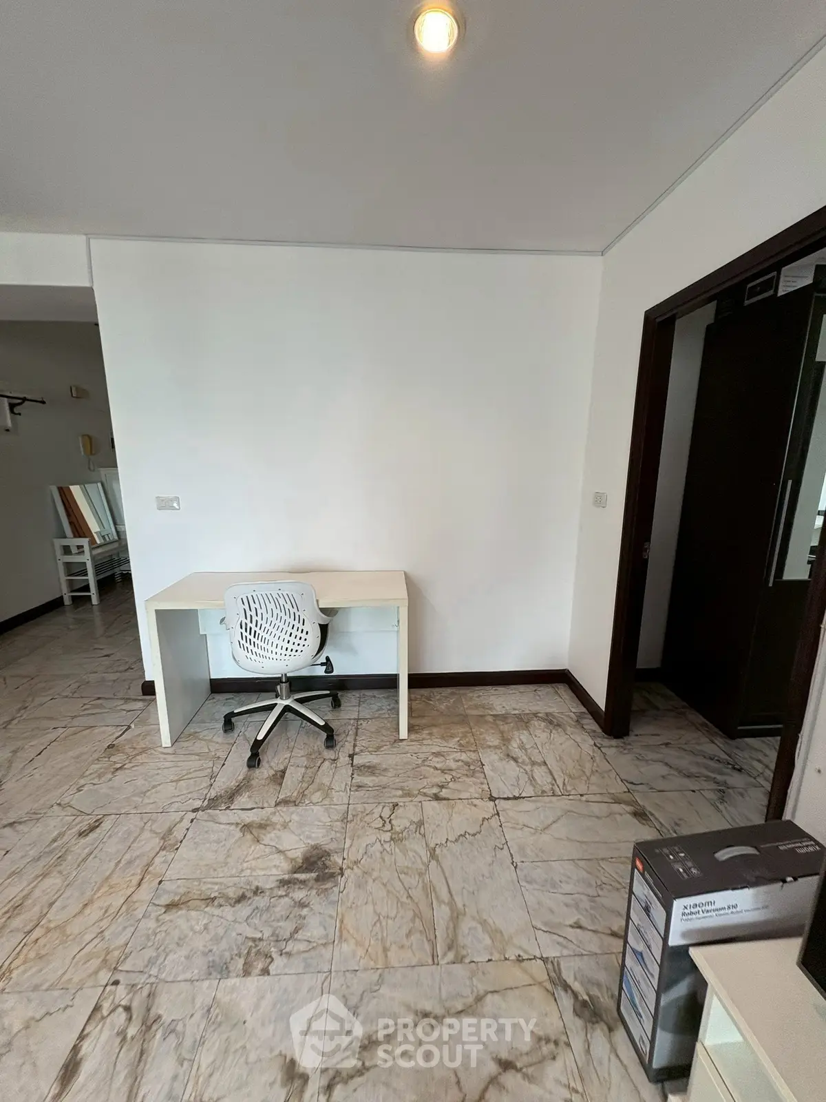 Spacious study area with modern desk and chair on elegant marble flooring