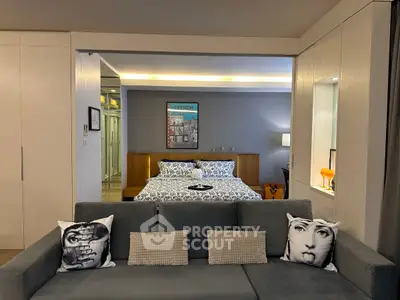 Stylish modern living room with artistic decor and cozy bedroom view