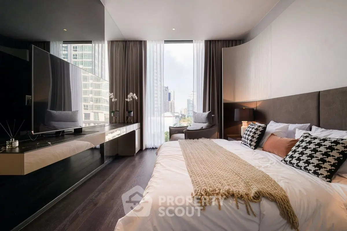Luxurious modern bedroom with city view, featuring elegant decor and large windows.