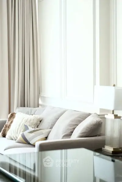 Elegant living room with plush sofa and stylish decor in a modern apartment.