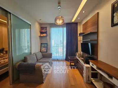 Modern living room with cozy sofa, stylish shelving, and large window offering city view.