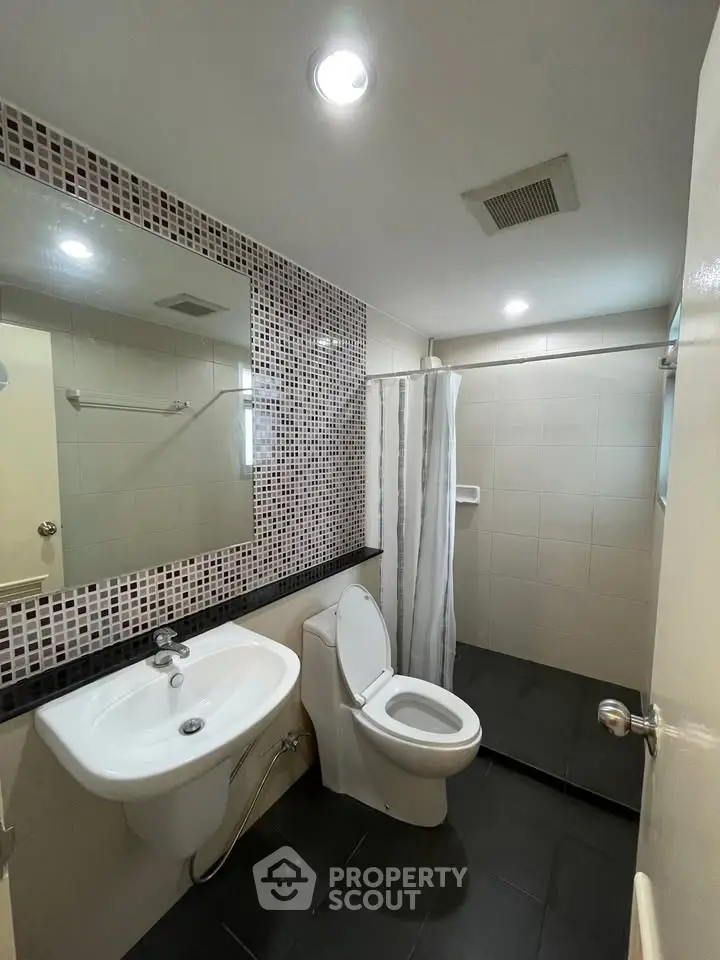 Modern bathroom with sleek fixtures and stylish tile accents